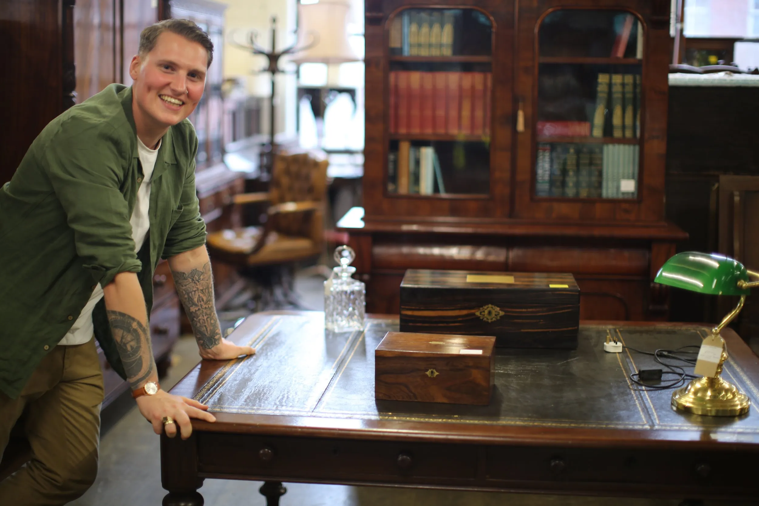 JB leaning on an antique table